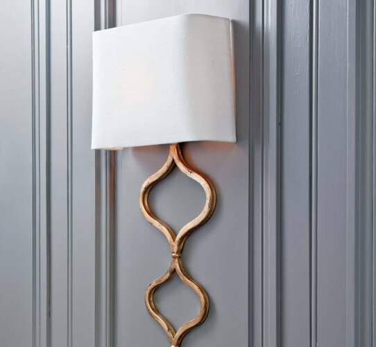 Gold sconce on a gray wall
