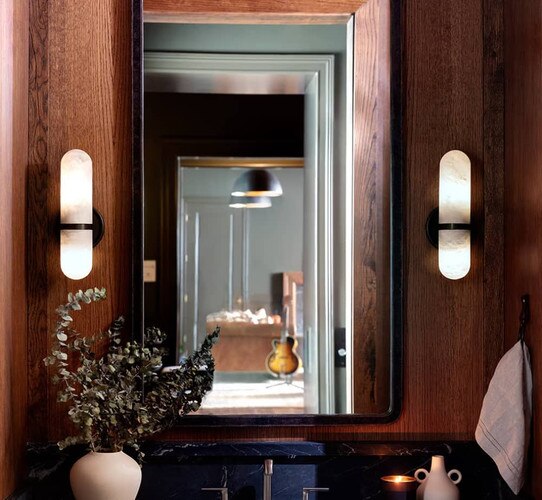 Bathroom mirror with two alabaster sconces flanking it
