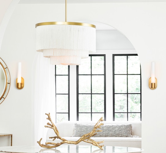 Brass scone with acrylic wick flanking opening of a living room