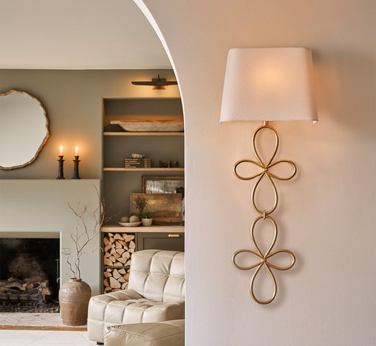 Gold leaf sconce flanking the entrance of a living room