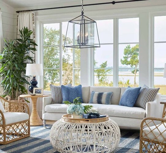 Living room with sofa rattan coffee table and lantern pendant