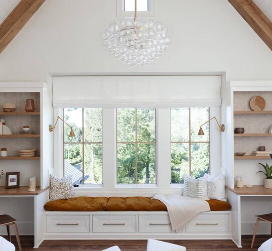 Window bench with sconces flanked by two desks