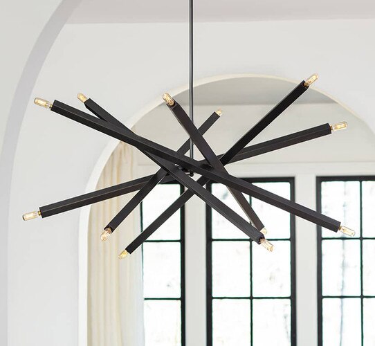 Multi-armed bronze chandelier in front of a living room doorway