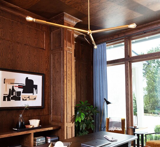 Three armed horizontal chandelier above a wooden desk in a wooden office