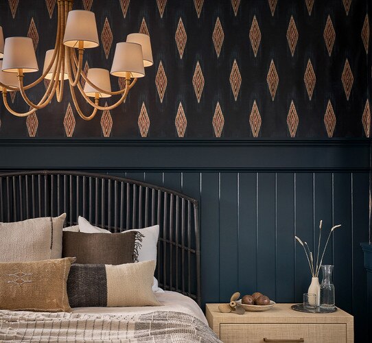 Bamboo wrapped chandelier above a bed in a bedroom