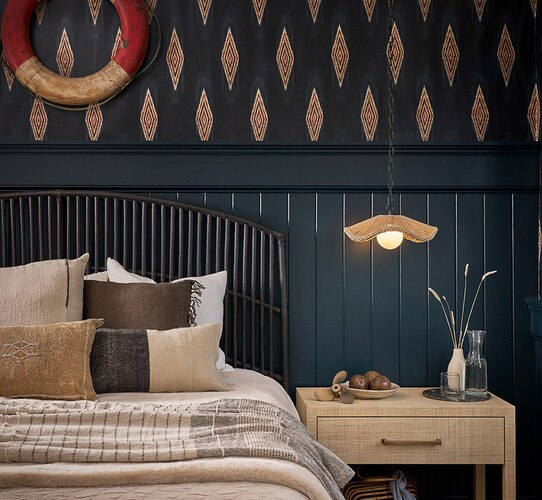 Small wicker pendant light above a nigthstand in a coastal bedroom