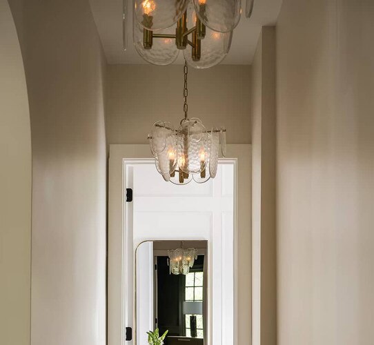 Glass and brass pendants in a hallway