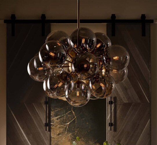 Smoke and natural brass chandelier with the lights on