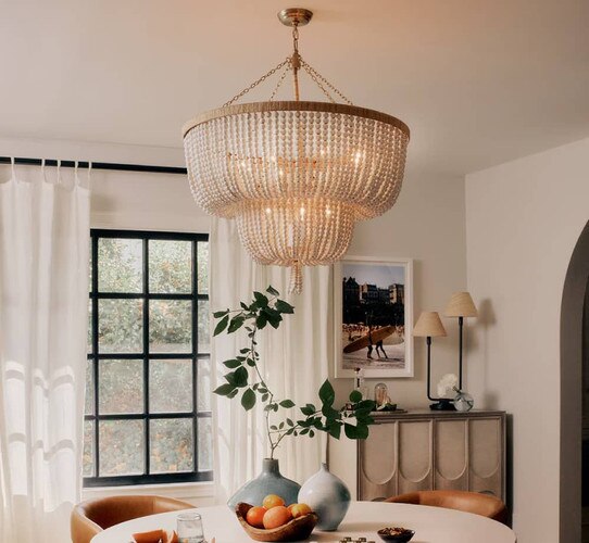 White beaded chandelier above a dining room table
