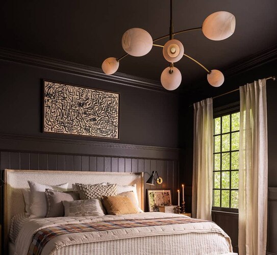 Alabaster chandelier above a bed