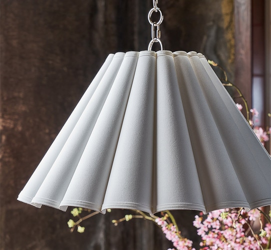 White scalloped pendant light above flowers