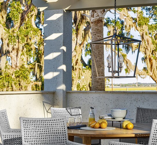 Concrete gazebo with dining table and black hanging lantern