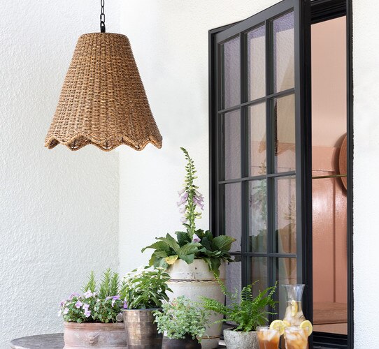 Pendant light in front of an open window with tea and jars of flowers