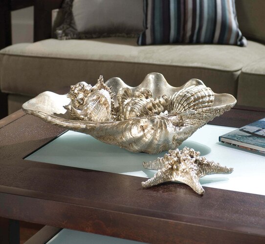 Clam shell bowl on a wood and glass coffee table