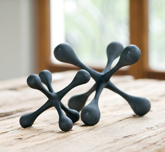 A small and large decorative iron jack