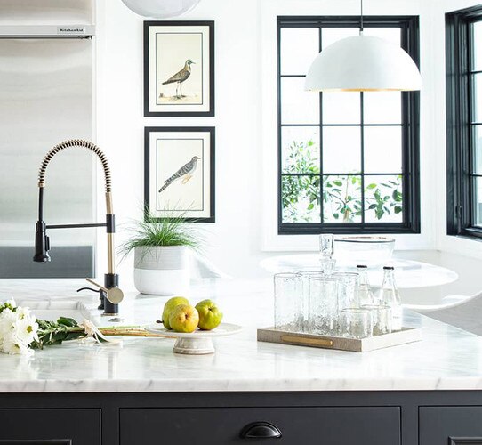 Kitchen island with square shagreen tray holding clear glasses