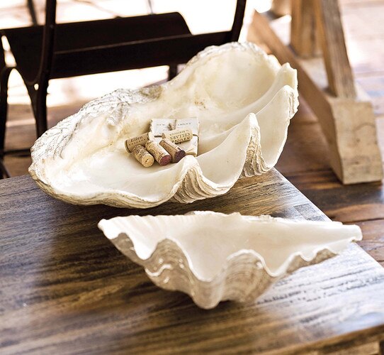 Large clam bowl with corks and a small notebook placed in the center