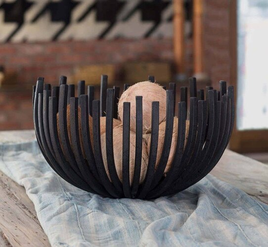 Webbed metal bowl on a wooden dining table