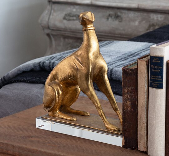 Golden dog bookend holding three vintage books