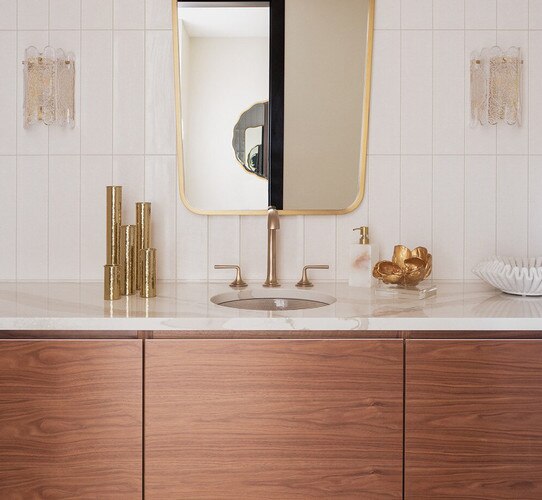 Kitchen counter with a gold flower sculpture and hammered gold candle holders