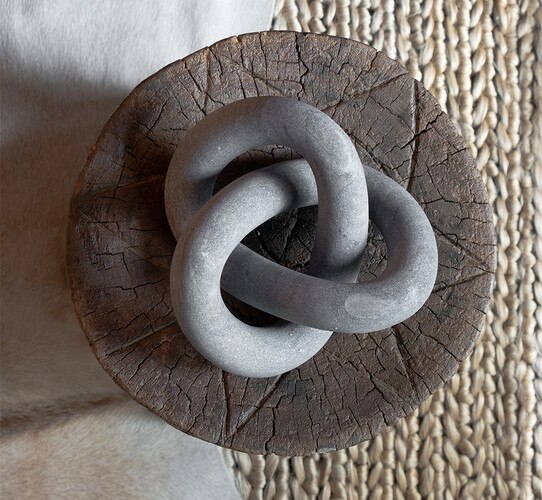 Intertwined Marble Sculpture on a wood table