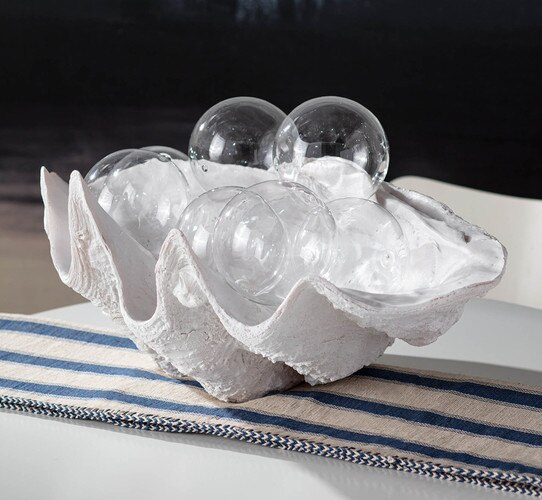 White clam bowl filled with large glass bubbles