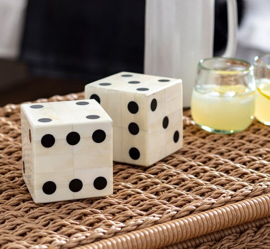 Large bone dice next to two glasses of lemonade