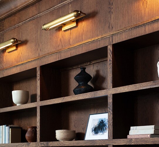 Black metal vase on built-in wooden shelves