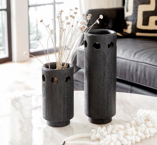Black wooden vase on a marble table