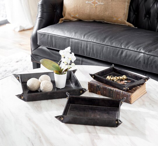 Leather trays holding vases change and decorative spheres