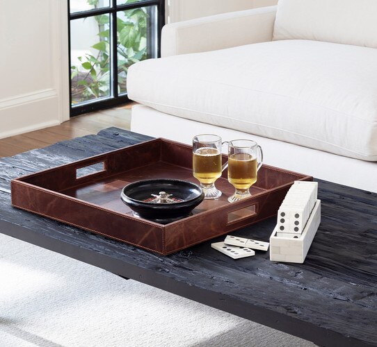 Large square leather tray holding two mugs on a black wood table