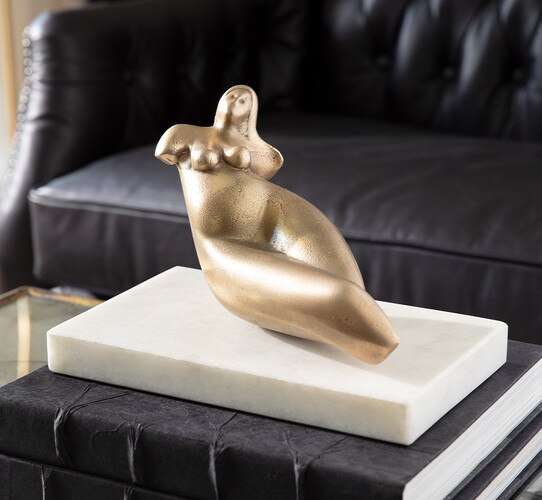 Sculpture of a woman resting on two leather books