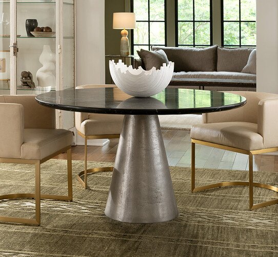 White metal dining table with a white decorative bowl in the center