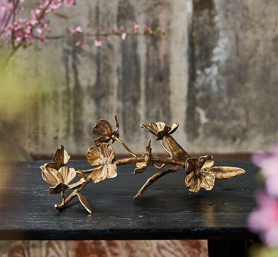 Metal cast of a dogwood stick resting on a table