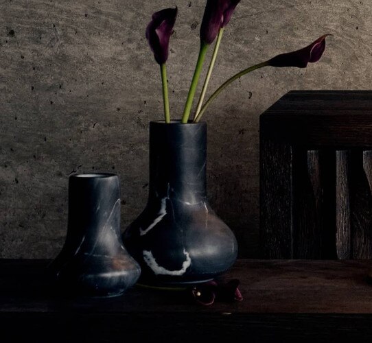 Black marble vases holding flowers