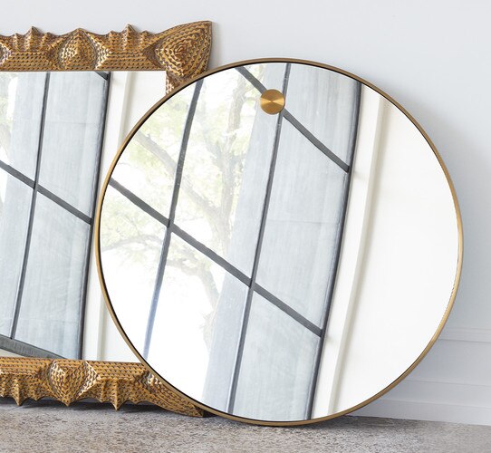 Brass circular mirror with brass circle at the top