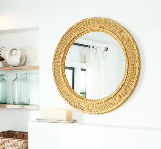 Rattan mirror above a mantle