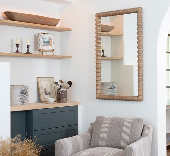 Wooden mirror above a swivel chair