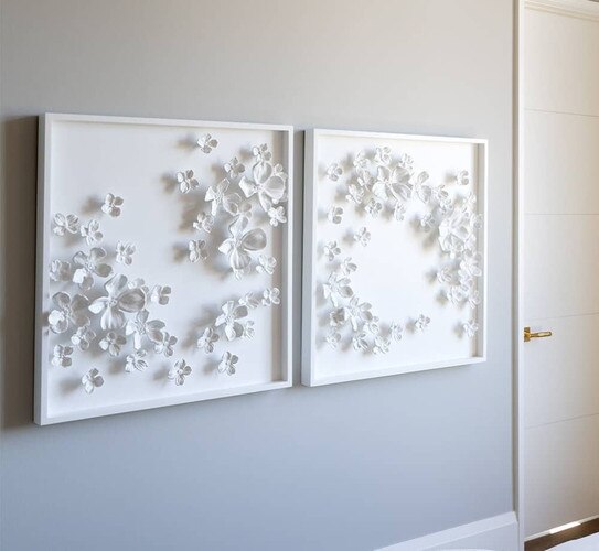 White ceramic pictures on a gray wall