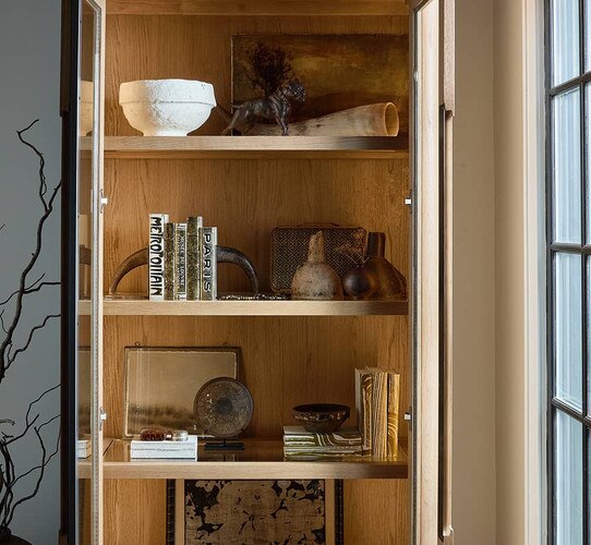 Wood cabinet holding décor and decorative books