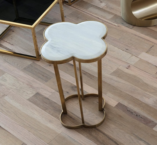 Clover shaped side table on a wood floor