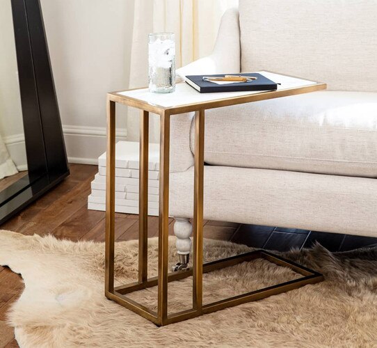 Brass and marble sofa hugger next to a white sofa