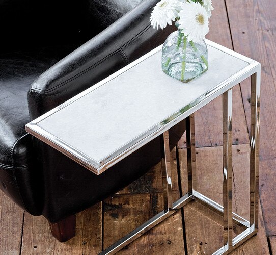 Nickel sofa hugger beside a black leather armchair