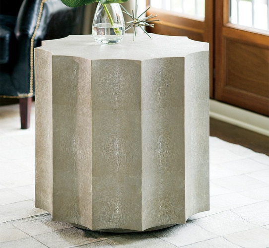 Scalloped shagreen table with a vase and a sculpture on top