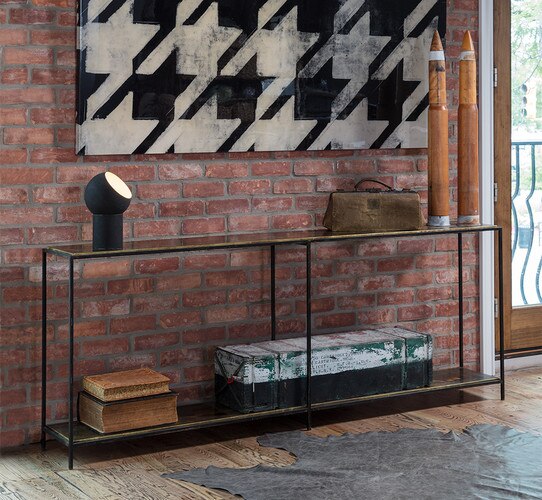 Metal console table under a large photo