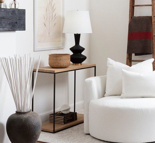 Wood and metal console table beside a white swivel chair