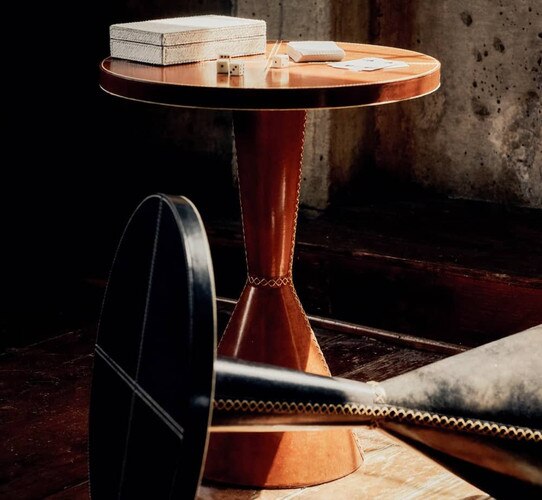 Leather side table holding cards and dice