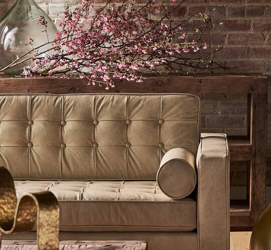 Leather sofa in front of a wood console table