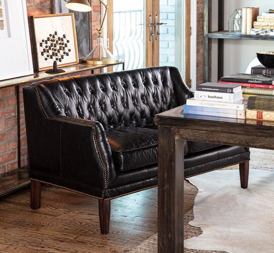 Leather sofa in front of wood desk