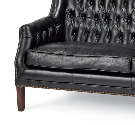 Leather sofa with dark wood legs